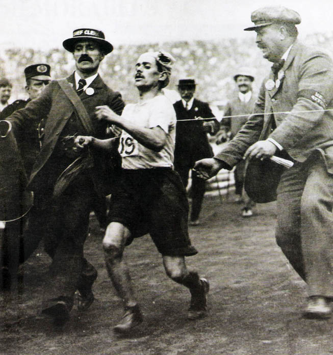 El pastelero italiano Dorando Pietri cruzó primero la meta en el maratón, pero fue descalificado por haber recibido la ayuda de un juez y del entonces periodista Arthur Conan Doyle, creador del famoso personaje Sherlock Holmes. (Foto: “Gran Libro de las Olimpíadas”).